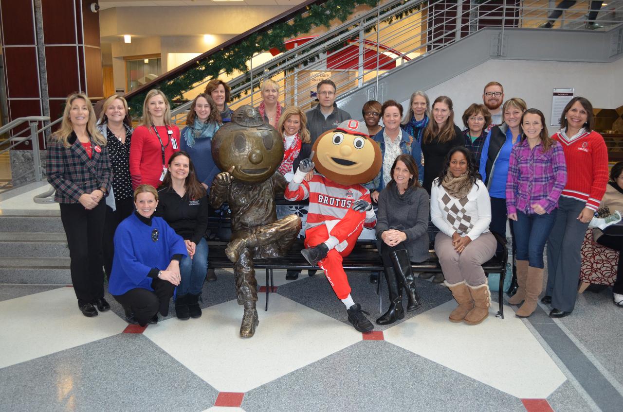 Buckeye Wellness Innovators pose with Brutus Buckeye next to the Brutus Buckeye bench statue in the Ohio Union.