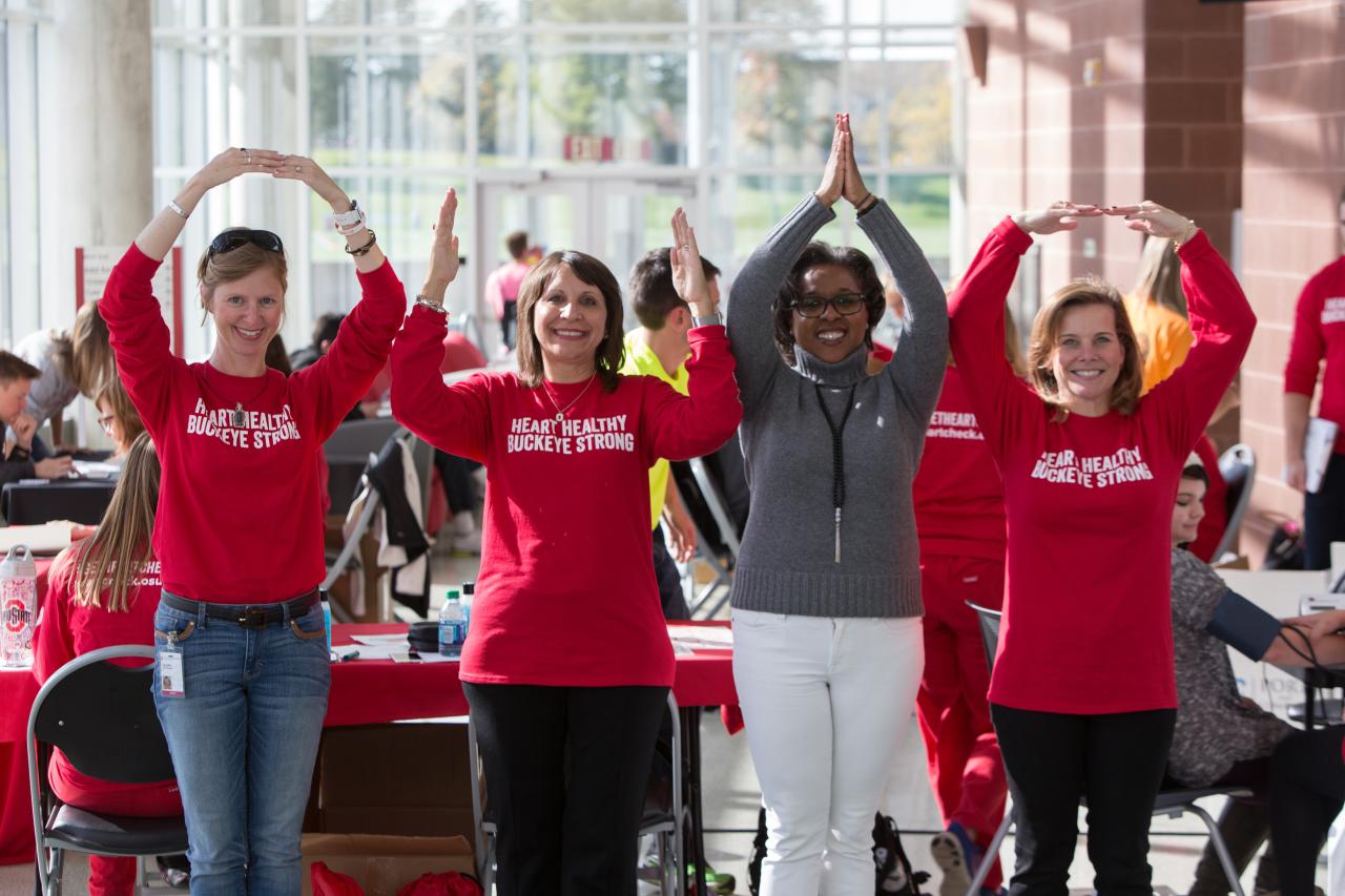 The heart checks team makes the O-H-I-O at the RPAC for the heart check event
