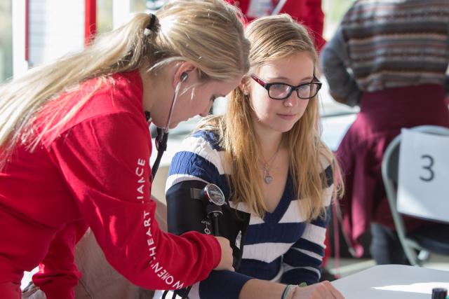 An Ohio State nursing student is conducting a heart check on another student. 