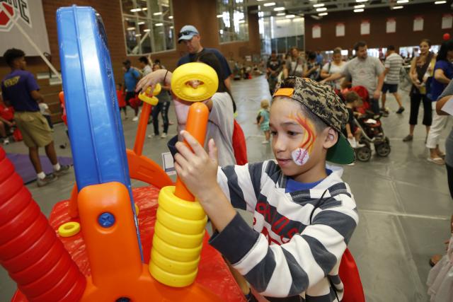 A young man enjoys a wellness game at the 2017 Family Wellness Expo