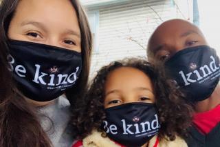 Family wearing face masks that say "Be Kind"