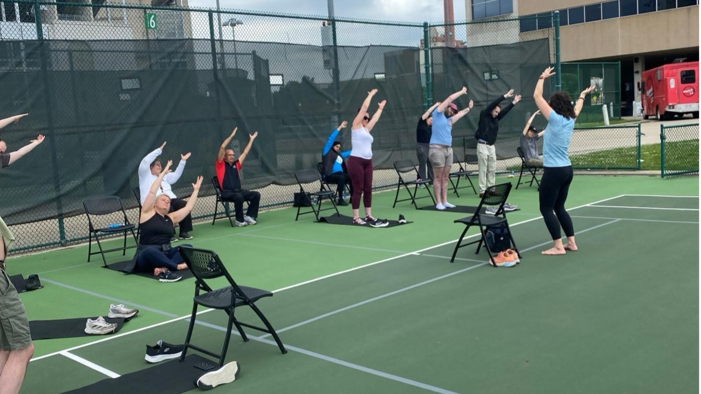 Staff engaging in a yoga session outside