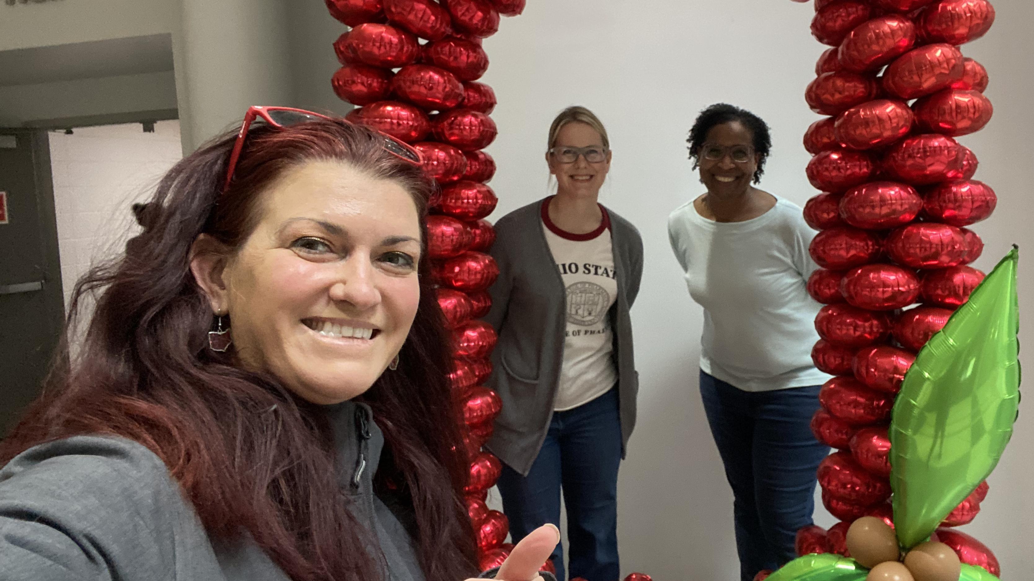 Emily Keeler in front of balloons and colleagues