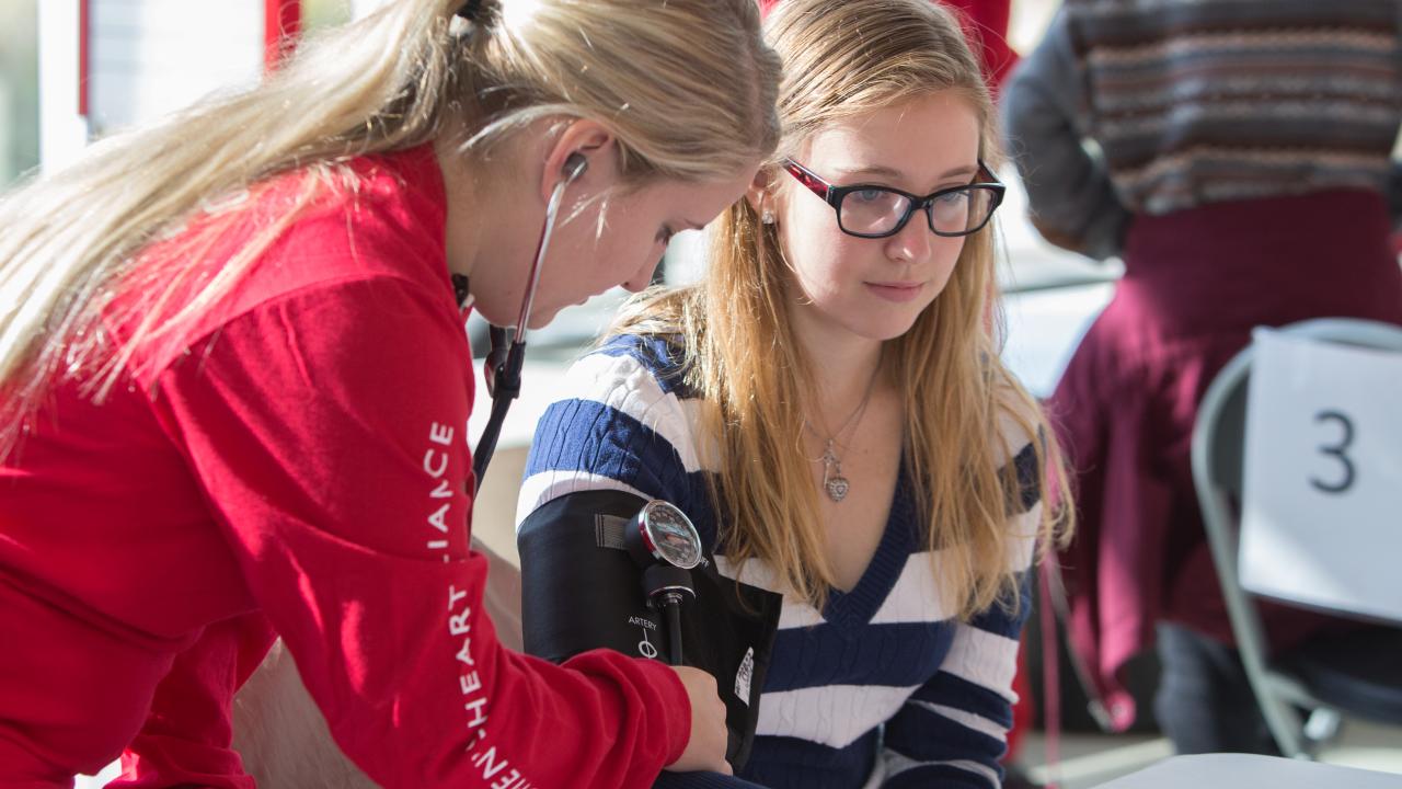 An Ohio State nursing student is conducting a heart check on another student. 