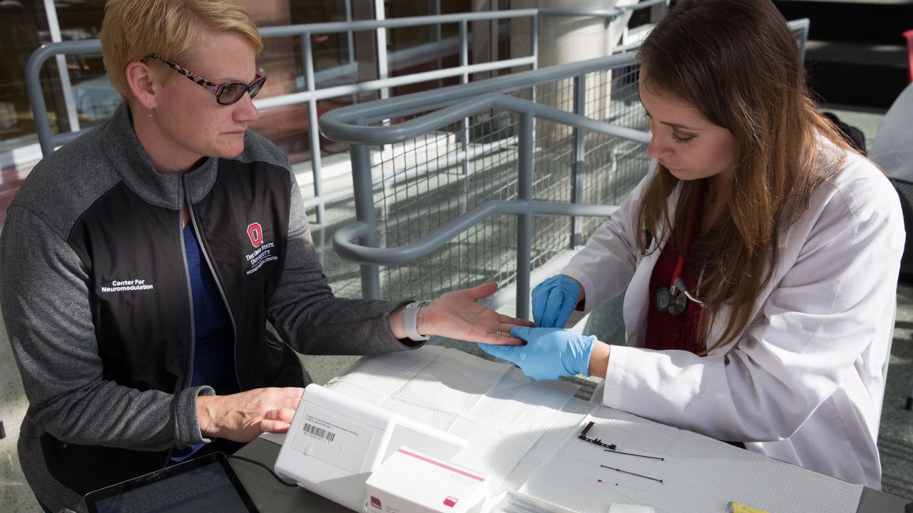 A participant is having her hemoglobin A1c tested by a nurse practitioner