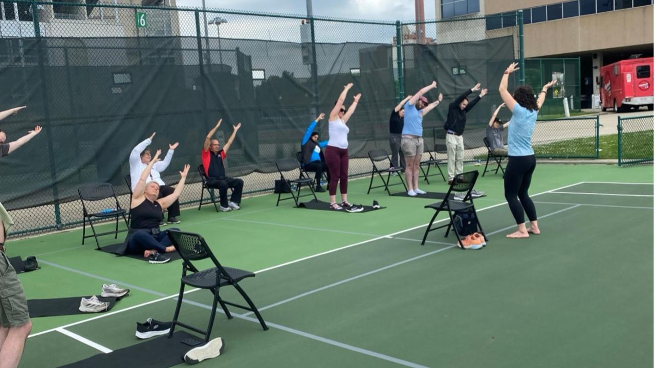 Staff engaging in a yoga session outside